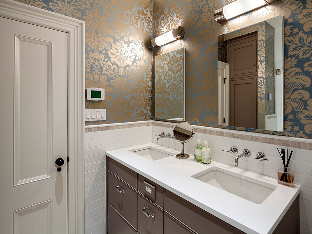 Bathroom with double sinks and ornate wallpaper pattern